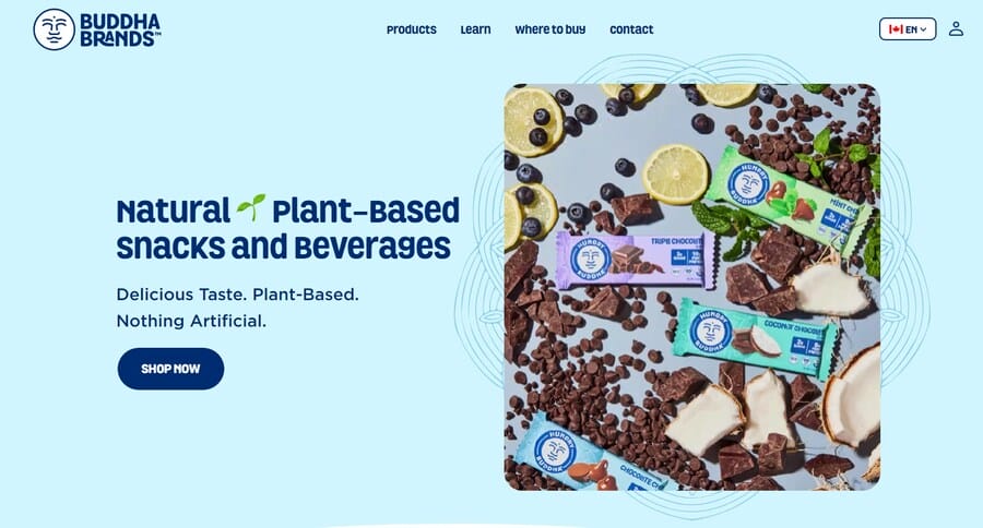 Buddha Brands homepage featuring plant-based snack products, fruit and chocolate imagery, with the headline “Natural Plant-Based Snacks and Beverages.”