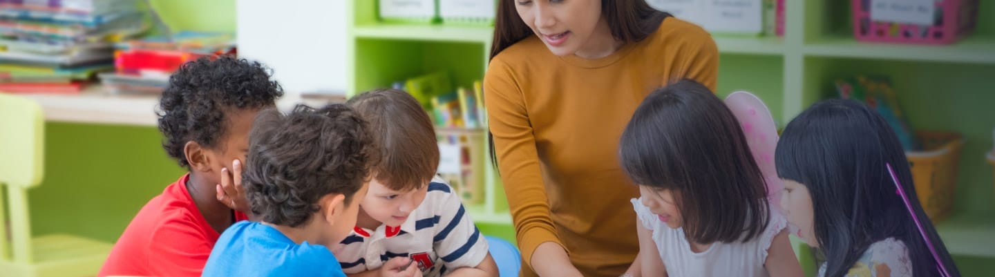 Children with their teacher learning in class