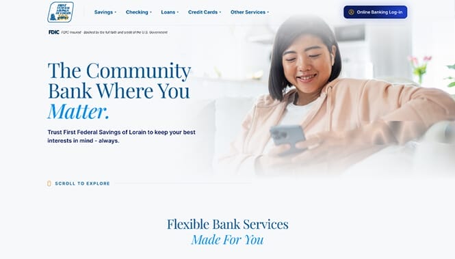 Banking website hero featuring a smiling woman using her phone with messaging about community-focused banking services.