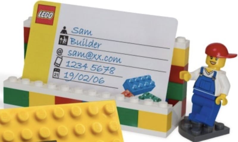 Lego figurines holding up a toy document that shows the Bradley Hand font in use.