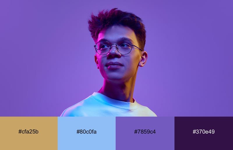 A guy with neon purple and orange light cast over him
