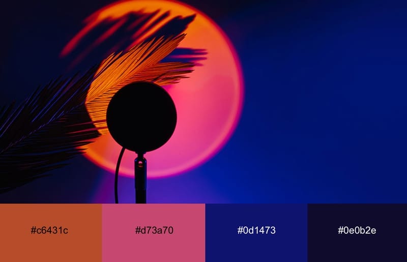 A palm tree leaf illuminated with neon orange 