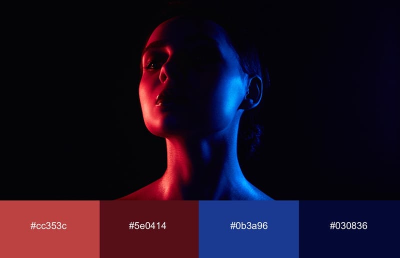 A woman with neon red and blue light cast over her