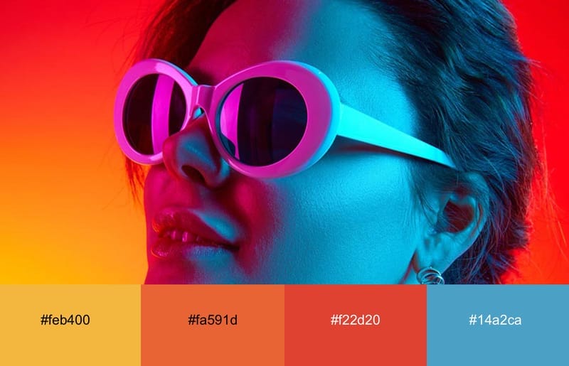 A girl with glasses bathed in neon red, yellow and blue light