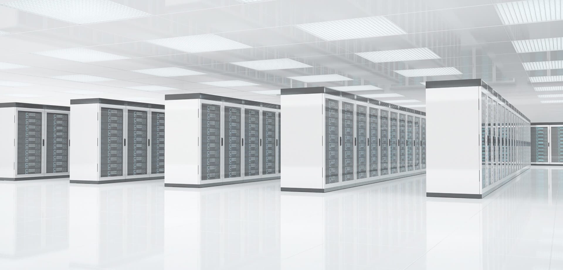 Large-scale data center facility with rows of white server racks stretching into the distance under bright overhead lighting