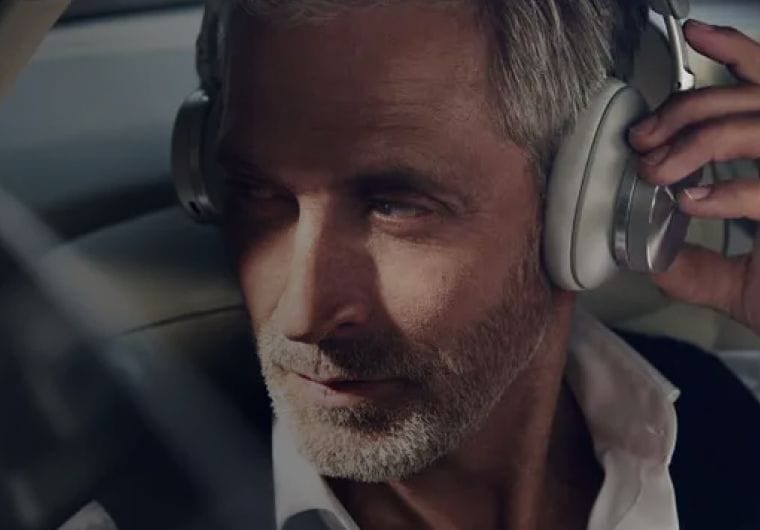 Man wearing headphones, relaxed expression.